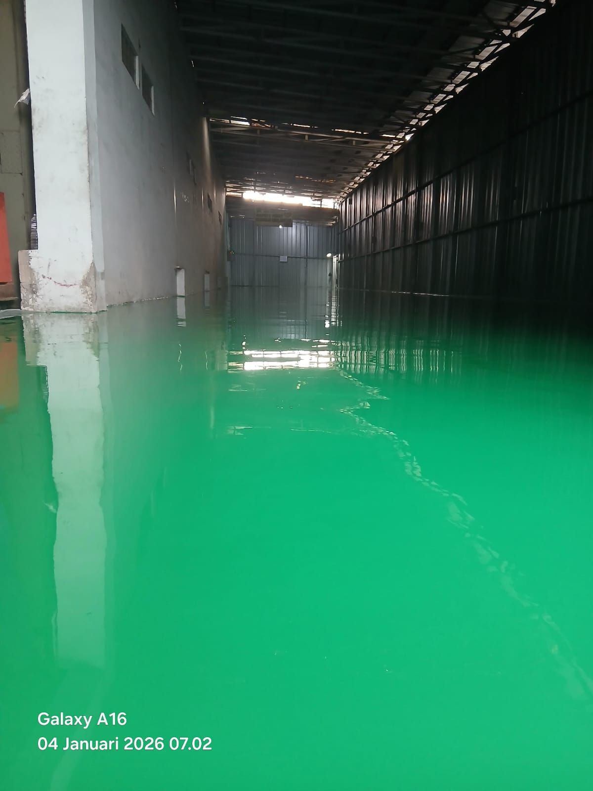 Lantai epoxy hijau dengan marka jalur kuning di antara mesin Hinomoto Indonesia (2/3)