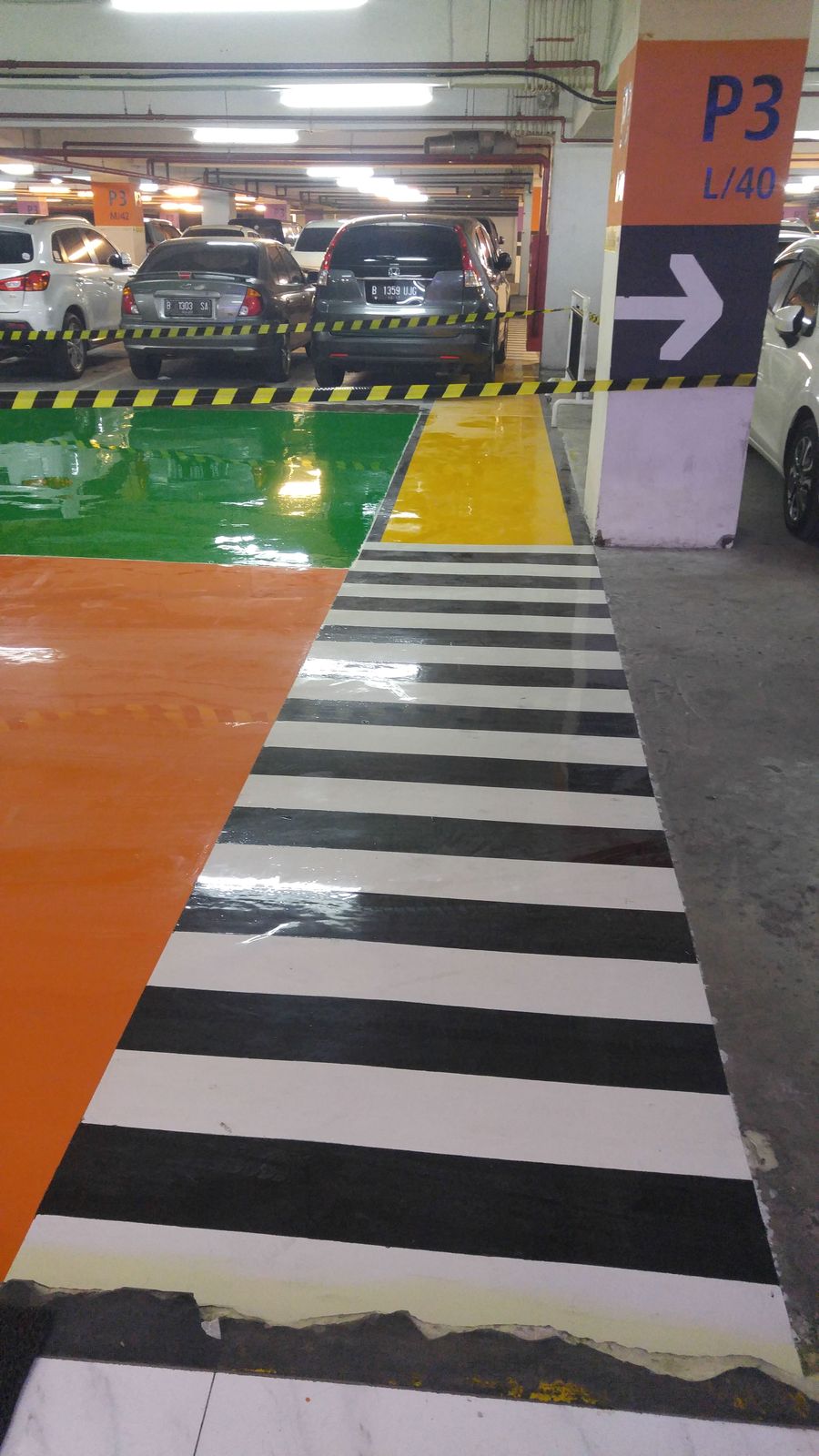 Jalur oranye dan zebra putih di lantai parkir Lippo Mall Puri (4/5)