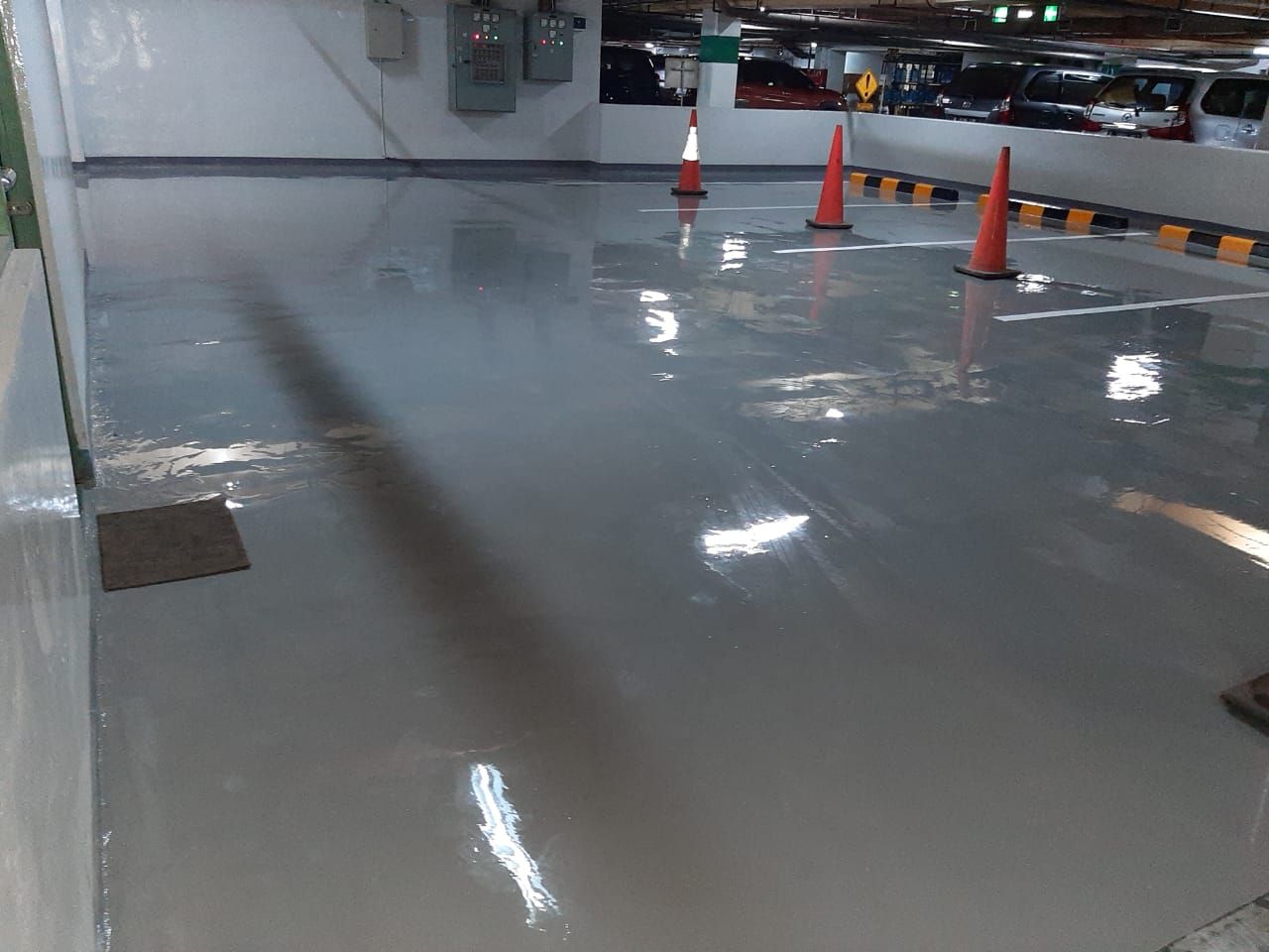 Ruang chiller Plaza Mandiri dengan lantai epoxy abu-abu kebiruan di antara jaringan pipa (2/3)
