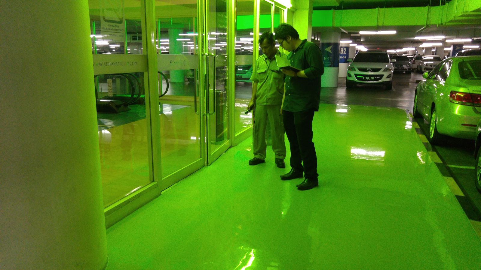 Area parkir Senayan City dengan lantai epoxy hijau mengilap dan mobil terparkir