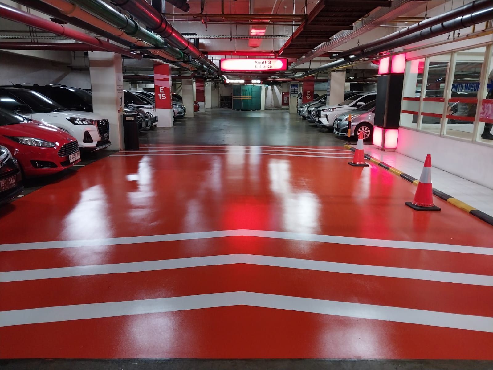 Zona parkir merah di Supermal Karawaci dengan marka jalur putih dan mobil terparkir